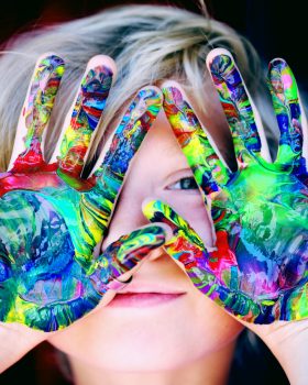 A KId With Multicolored Hand Paint